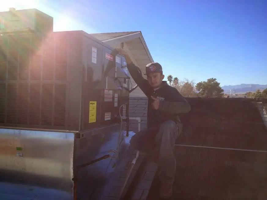 HVAC technician performing AC Tune-Up on a rooftop unit in Boise City